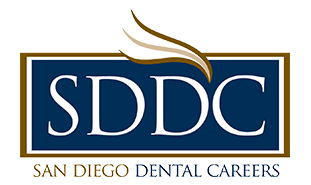 The image is a logo consisting of text with a graphic element on the left side, representing a stylized letter  S  with a feather-like design above it. The text includes  SDDC,  which stands for San Diego Dental Careers, and below that,  SAN DIEGO DENTAL CAREERS.